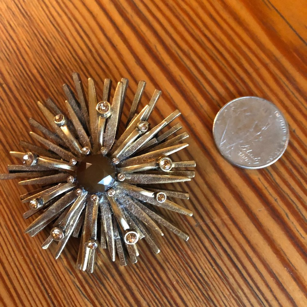 Gold-tone Brooch with center stone.